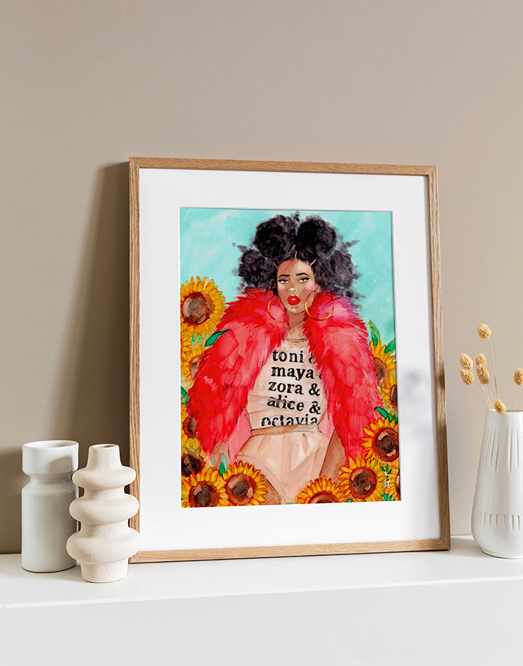 Illustration in a light frame of a beautiful black woman wearing a red fur and a toni morrisson tee sitting amongst  sunflowers by Tatiana Poblah